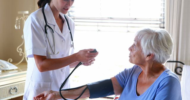 Nurse Taking Senior Woman's Blood Pressure at Home - Download Free Stock Images Pikwizard.com