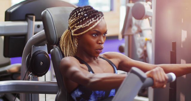 Determined Woman Exercising on Rowing Machine in Gym - Download Free Stock Images Pikwizard.com