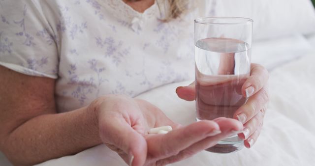 Senior Woman Holding Medication and Glass of Water - Download Free Stock Images Pikwizard.com