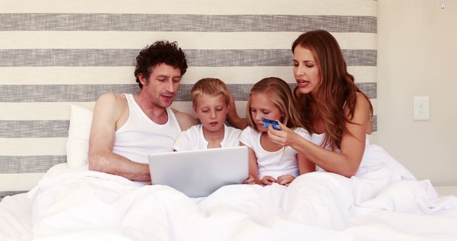 Family in Bed Shopping Online Watching Computer Together - Download Free Stock Images Pikwizard.com