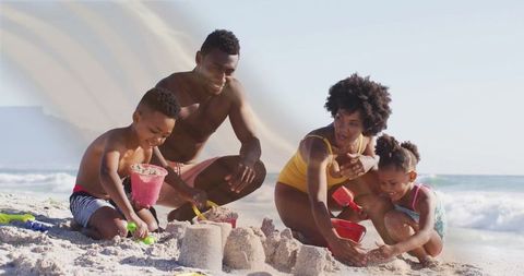 Family Enjoying Quality Time Building Sandcastles on Sunny Beach