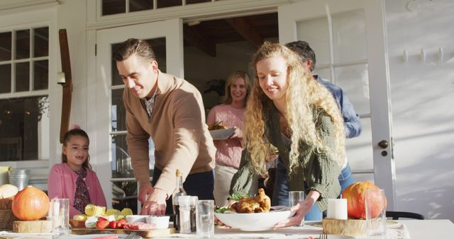 Image of happy caucasian parents, daughter and grandparents bringing food to table for family meal. Family, domestic life and togetherness concept digitally generated image.