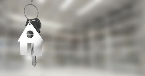 Silver house keys hanging symbolizing new home ownership