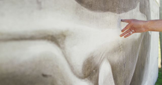 Image of hand of caucasian male artist touching mural on wall. Freedom, creativity, art and hobbies concept digitally generated image.