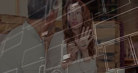 Professional Woman Collaborating with Colleague in Casual Cafe Setting