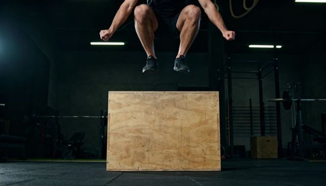 Explosive plyometric box jump showcasing athletic power, focus, and lower-body strength