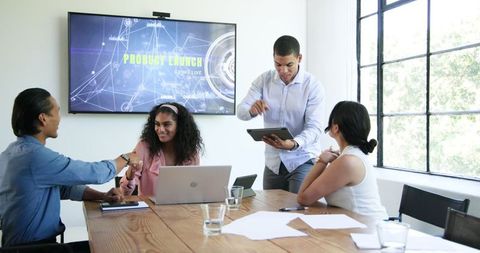 Diverse Team Celebrating Successful Project Meeting in Office