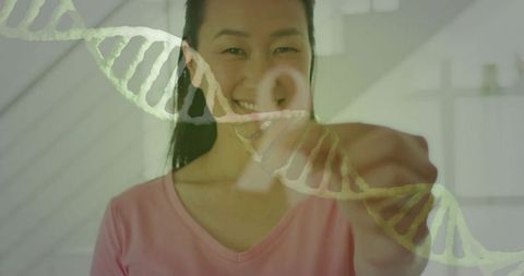 Smiling korean woman touching virtual dna helix in bright interior, genomics concept