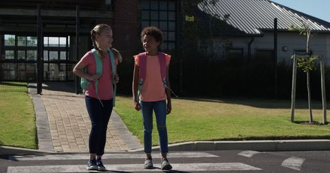 Girls Cross Road With Joy and Safety Near School