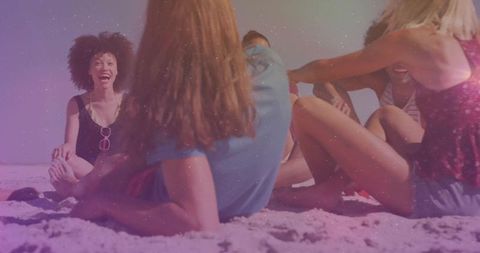 Group of Friends Relaxing and Laughing Together on Sunny Beach