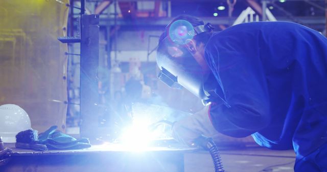 Welder In Protective Gear Working With Bright Sparks In Industrial Factory - Download Free Stock Images Pikwizard.com