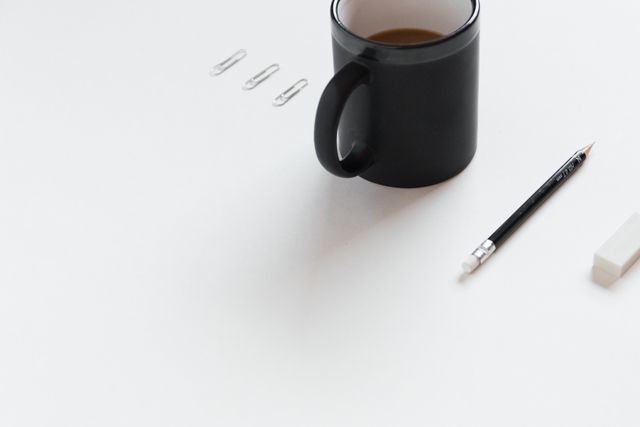 Minimalist Office Desk with Coffee Mug, Pencil, Eraser, and Paper Clips - Download Free Stock Photos Pikwizard.com