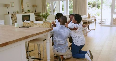 African American Family Preparing Children for School in Cheerful Living Room