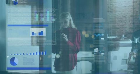 Businesswoman analyzing data in modern office with digital graphs