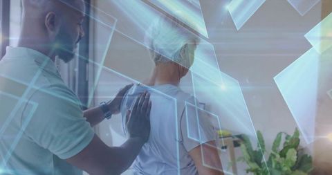 Therapist assisting senior with virtual reality assistance