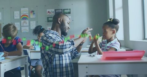 Teacher demonstrating candlestick chart to student in classroom for financial literacy
