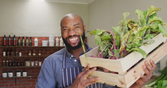 Happy Farmer Holding Freshly Harvested Greens in Wooden Crate - Download Free Stock Images Pikwizard.com