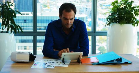 Focused Businessman Using Tablet in Modern Office with Technology - Download Free Stock Images Pikwizard.com