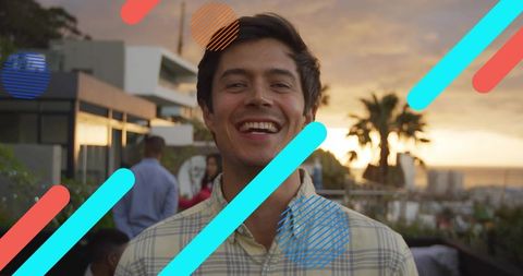 Smiling man enjoying rooftop sunset party with coastal cityscape and graphic overlays