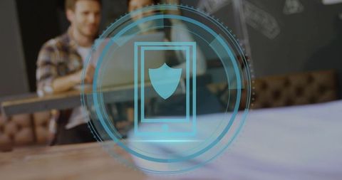 Displaying mobile security hologram over coworking desk with shielded smartphone interface