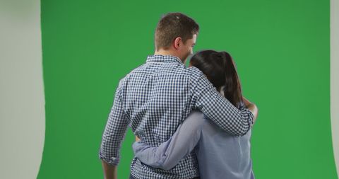 Couple embracing with green screen for creative background use