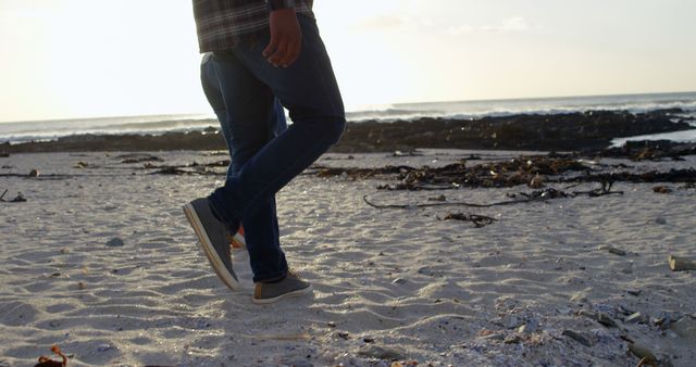 Person Walking on Sandy Beach During Sunset - Download Free Stock Images Pikwizard.com