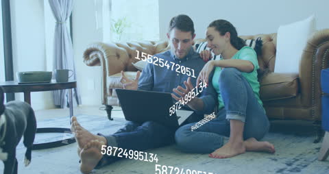 Couple Analyzing Data with Laptop in Contemporary Home