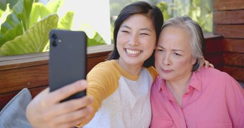 Mother and Daughter Laughing and Taking Facetime Selfie