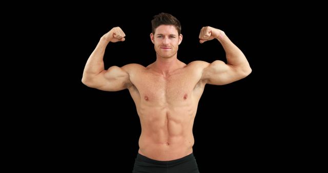 A young Caucasian man flexes his muscles confidently against a black background, with copy space. His strong physique and proud stance suggest he might be a fitness model or athlete.