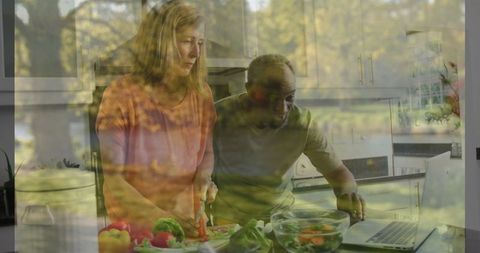 Couple Cooking Together Following Online Recipe