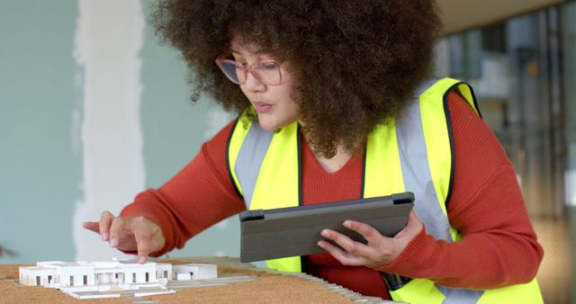 Female Architect Working on Architectural Model with Tablet - Download Free Stock Images Pikwizard.com