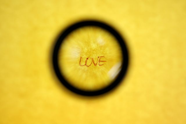 Yellow background highlights word ‘LOVE’ centered within a magnifying glass effect. Ideal for concepts of love, focus, analysis or romantic themes. Useful for blogs, advertisements, posters promoting love, romantic literature, or educational purposes.