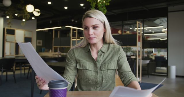 Businesswoman Analyzing Documents in Modern Open Office - Download Free Stock Images Pikwizard.com