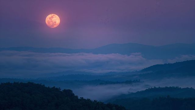 Majestic full moon over misty mountain valley
