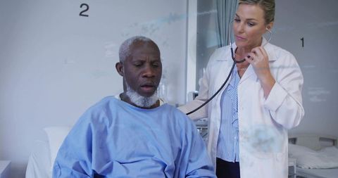 Doctor examining patient with stethoscope in hospital bed during clinical consultation
