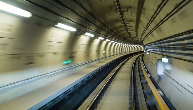 High-speed metro tunnel curving rails motion blur underground transit dynamic modern commute