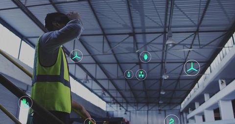Engineer with VR Glasses on Staircase Observing High-Tech Icons