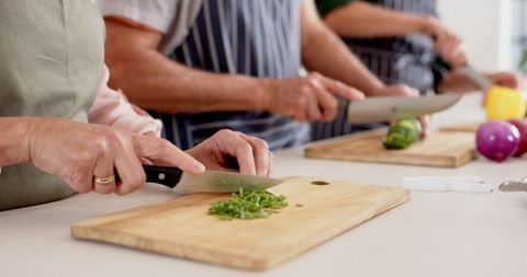 Diverse Group Friends Cooking Together Chopping Vegetables