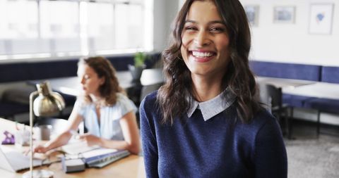 Biracial Businesswoman Smiling in Contemporary Office Environment - Download Free Stock Images Pikwizard.com