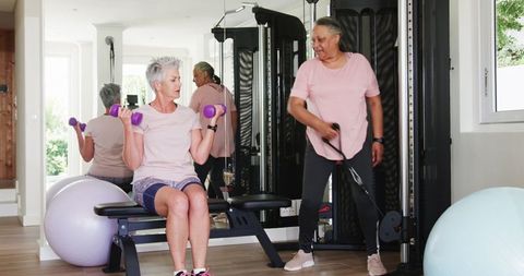 Senior couple embracing fitness routine together at home gym