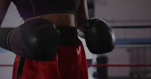 Female Boxer Ready in Boxing Ring Wearing Gloves
