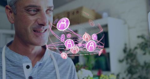 Middle-aged man watching holographic globe displaying pink network icons in home interior