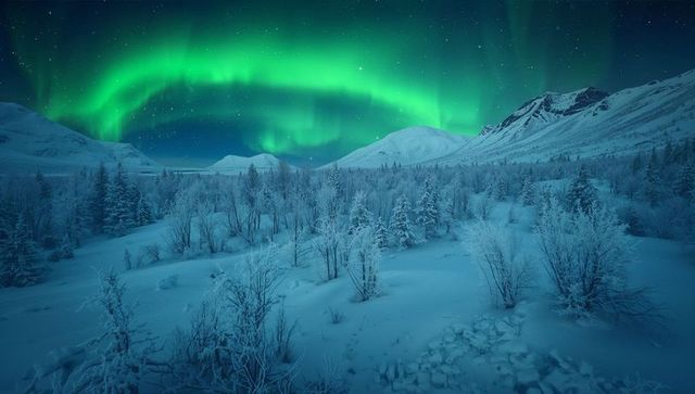 Vivid aurora borealis illuminating icy winter landscape