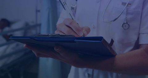 Nurse writing patient notes on blue clipboard at bedside with stethoscope and caring focus