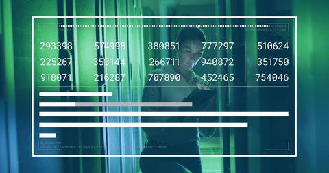 Network Engineer Analyzing Data in Server Aisle with Tablet