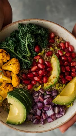 Lowering speckled bowl rotating vibrant plant-based salad, hands revealing organic nourishment