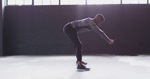 Man Stretching Indoors in Natural Light - Download Free Stock Images Pikwizard.com