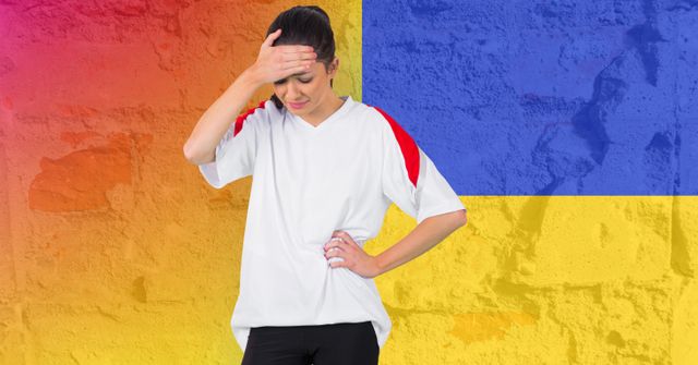 Stressed caucasian female athlete against ukraine flag design background. ukraine crisis, invasion and international relations concept