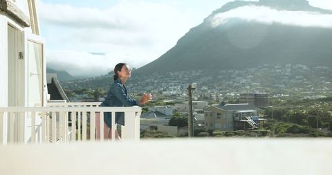 Woman Enjoying Peaceful Mountain View with Morning Coffee