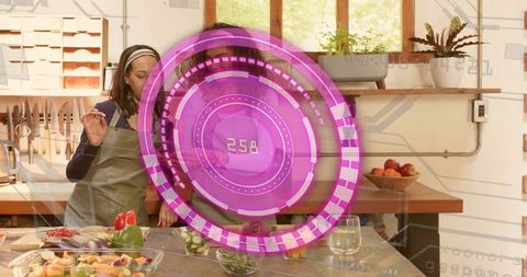 Two women chopping vegetables with holographic kitchen interface for smart meal prep